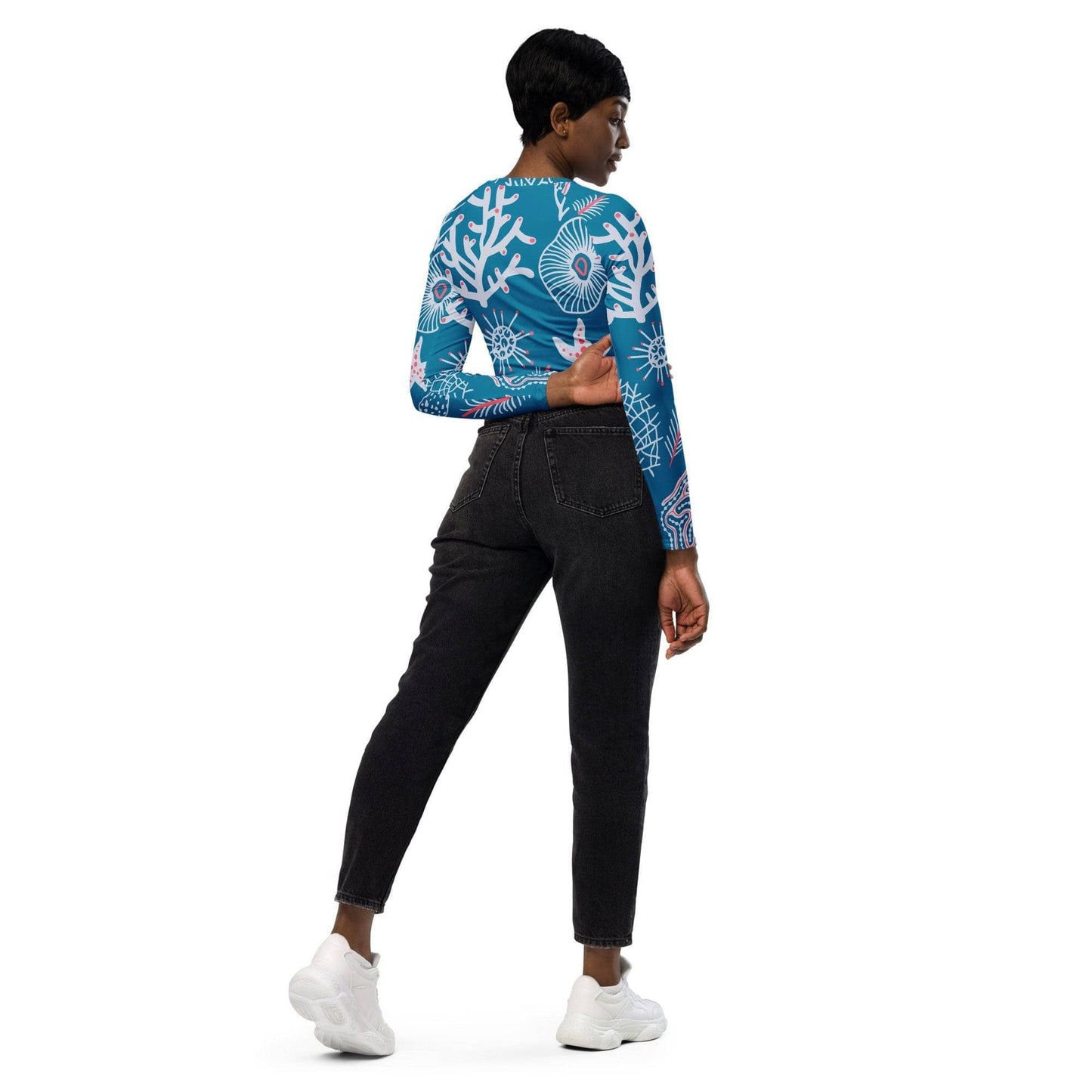 Woman wearing blue and white patterned eco-friendly fashion top paired with black jeans and white sneakers