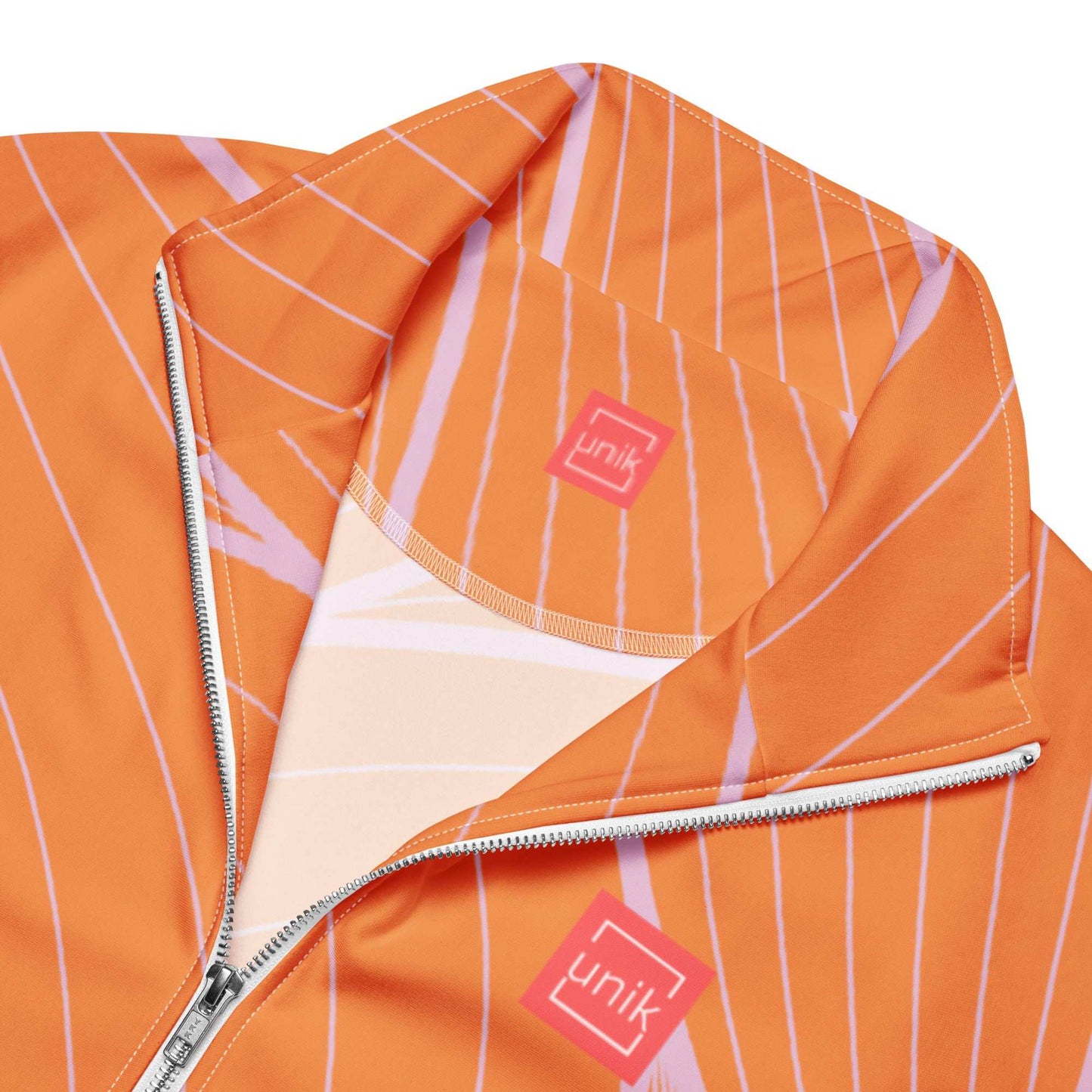 unik.fashion orange sustainable track jacket with white zipper and striped pattern close-up